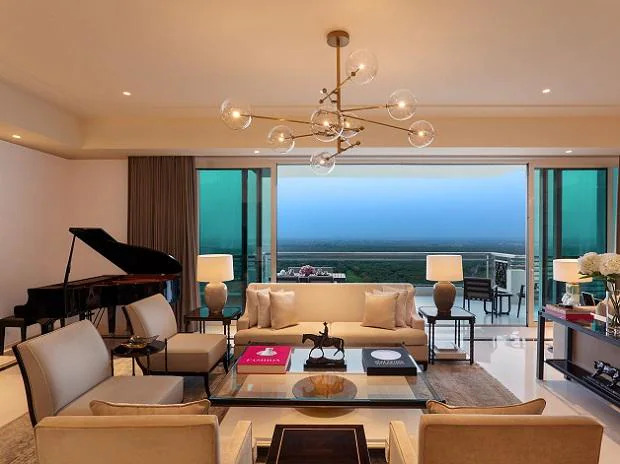 A living room with a view at DLF Camellias. The project has 429 units in 16 towers, with only one unit per floor and residences of 6,290-7,350 sq ft. It also has 14 penthouses